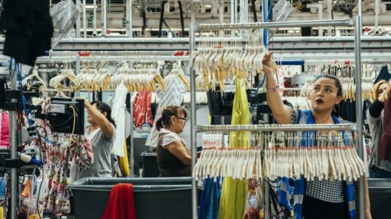 Workers at Rent the Runway’s warehouse in New Jersey. Photograph: George Etheredge/The New York Times