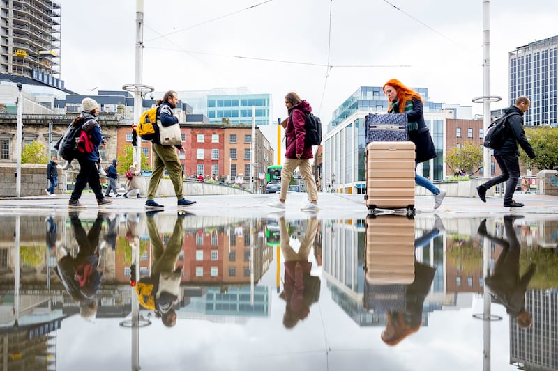 People cross the road at Marlborough Street and Eden Quay after a heavy rain shower. Photograph: Tom Honan for The Irish Times.