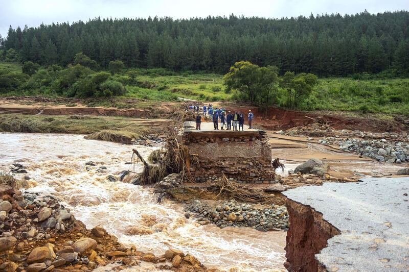 Timber company workers stand stranded on a damaged road  at Charter Estate, in eastern Zimbabwe, after the area was hit by the cyclone Idai. Photograph: Zinyange Auntony/AFP/Getty