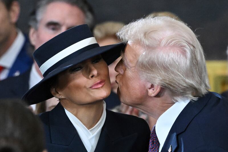 Donald Trump kisses his wife Melania, who was wearing a hat by New York-based milliner Eric Javitz, during his inauguration as US president on Monday. Photograph: Saul Loeb/AP