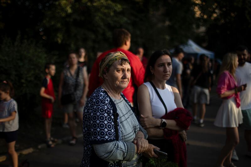 People watching recovery efforts near a building struck by a Russian missile in Kryvyi Rih, Ukraine. Photograph: Diego Ibarra Sanchez/The New York Times
                      