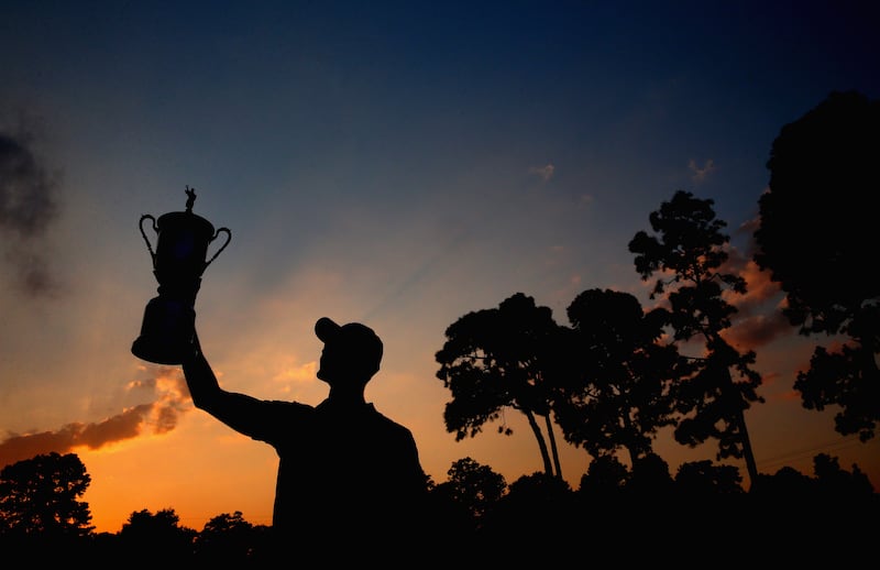 Martin Kaymer of Germany celebrates with the trophy after his eight-stroke victory in the 114th US Open at Pinehurst in 2014. Photograph:  Andrew Redington/Getty Images