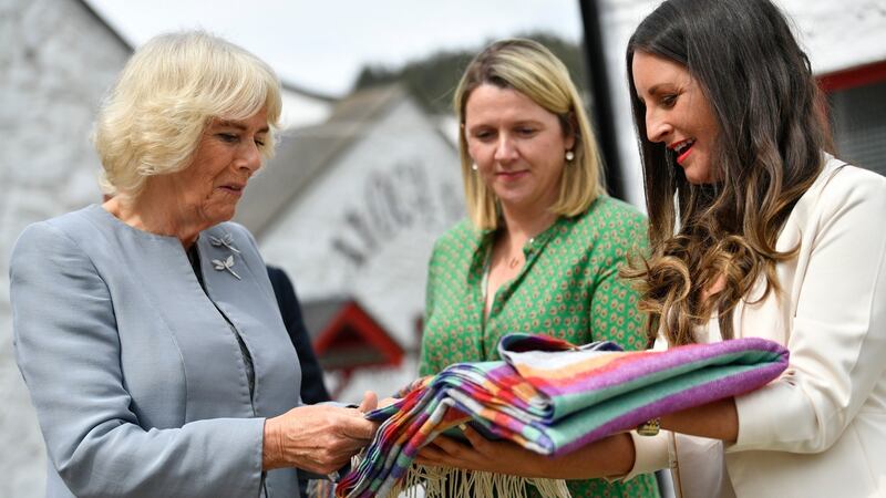 Camilla, Duchess of Cornwall  receives a gift of a blanket for the Duke and Duchess of Sussex’s son Archie as she visits the Avoca Mill. Photograph:  Neil Hall/Pool/Getty Images