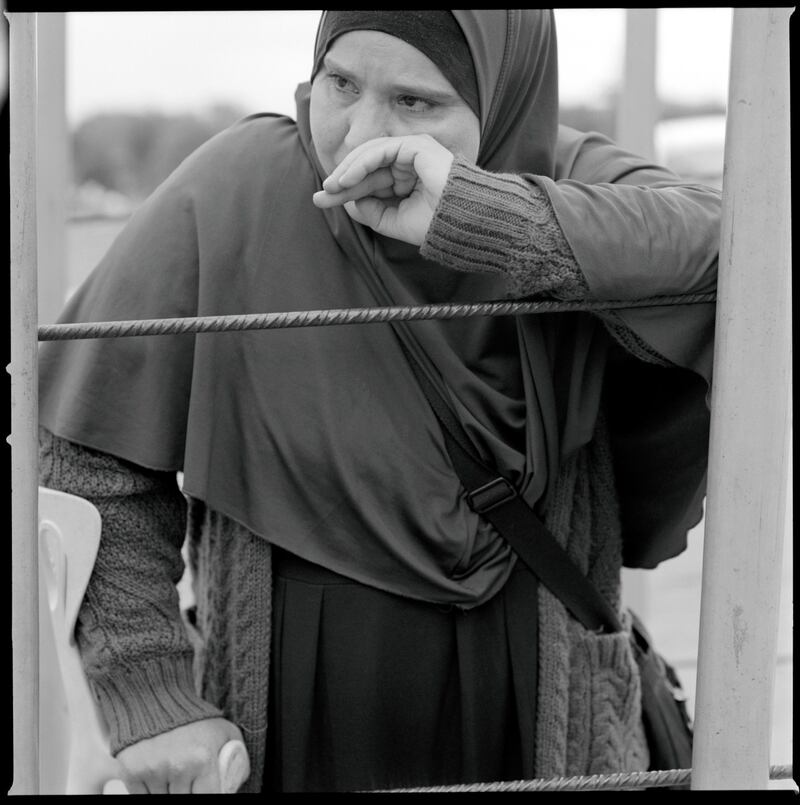 A woman waits at the Barrio Chino border crossing.