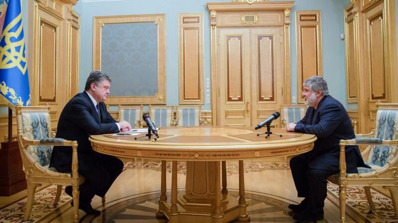 Ukraine’s president Petro Poroshenko (left) speaks with Igor Kolomoisky, the governor of Dnipropetrovsk region, at the presidential office in Kiev on Wednesday. Mr Poroshenko accepted the resignation of Mr  Kolomoisky in a show of authority that could escalate a dangerous power struggle. Photograph: Mikhail Palinchak/EPA