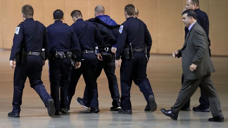 Police officers and US Secret Service take a man away in handcuffs from a campaign rally for Republican presidential nominee Donald Trump in Reno, Nevada. Photograph:  Chip Somodevilla/Getty Images