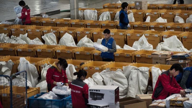 Workers at a JD.com technology products warehouse in Beijing. Photograph: Gilles Sabrie/New York Times