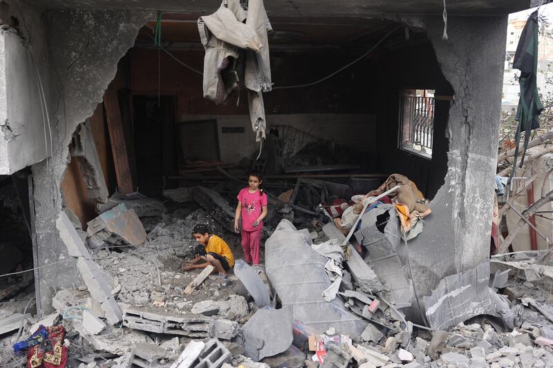 Palestinians children search through the rubble of their home in Nuseirat, central Gaza, on Sunday, a day after the operation by Israeli special forces to free hostages taken by Hamas on October 7th. Photograph: Eyad Baba/AFP via Getty Images