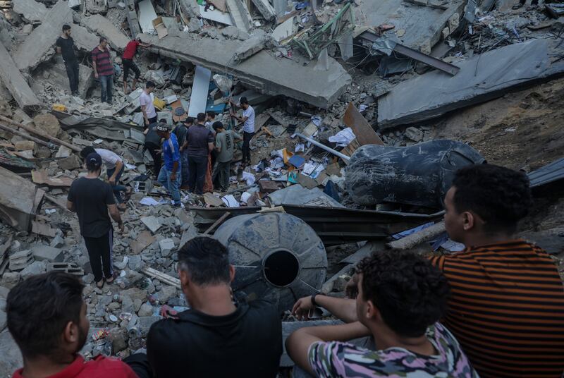 People stand among the rubble of the Greek Orthodox Saint Porphyrius Church following an overnight airstrike in Gaza. Photograph: EPA