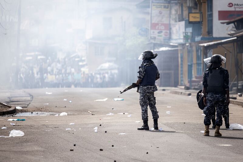 Police officers disperse  supporters of the  All People's Congress during a protest in Freetown on Wednesday over alleged electoral fraud ahead of the Sierra Leone general elections. Photograph: John Wessel/AFP 