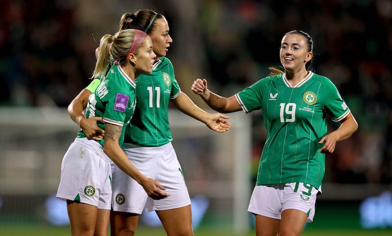 Ireland’s Katie McCabe celebrates scoring the third goal against Georgia with Julie-Ann Russell and Abbie Larkin at Tallaght Stadium. Photograph: Ryan Byrne/Inpho 