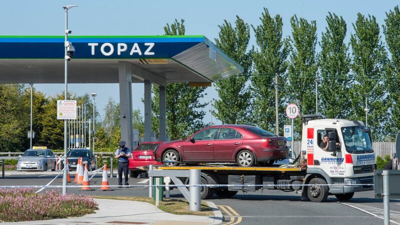 A car is removed from the scene on the Clonshaugh Road, Dublin, after a man was shot and critically injured in an attack believed to be linked to the Kinahan-Hutch feud. Photograph: Brenda Fitzsimons/The Irish Times