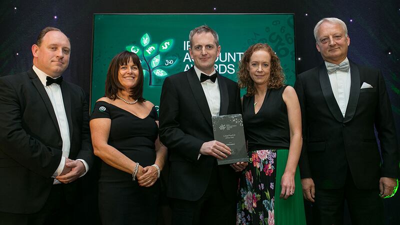 Gary Cullen, Head of Client Management at Harvest Financial Services presents the Large Practice of the Year Award to RSM Ireland team