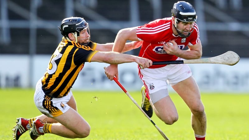 Mark Ellis goes past Richie Hogan. Photo: Ken Sutton/Inpho