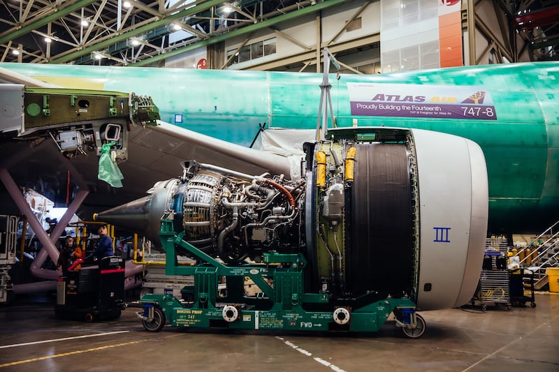 An electric tug is used to guide the engine into place. Photograph: Lindsey Wasson/The New York Times