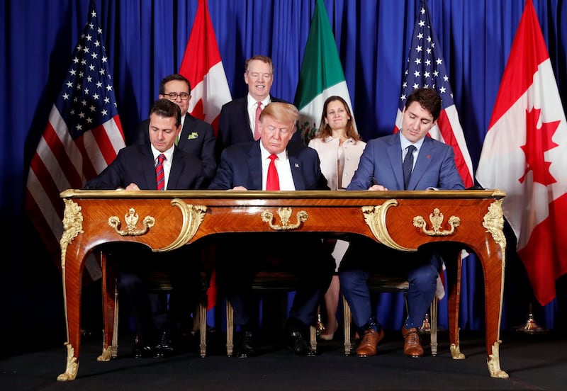 US president Donald Trump, Canada’s prime minister Justin Trudeau and Mexico’s president Enrique Pena Nieto, sign documents during the USMCA signing ceremony before the G20 leaders summit in Buenos Aires on November 30th Photograph: Kevin Lamarque/Reuters