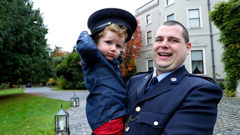 Garda Eoghan O’Neill, who was awarded a certificate of bravery for rescuing a woman from the sea, with his son Faolán (2),  at the National Bravery Awards at Farmleigh House in Dublin. Photograph: Maxwells