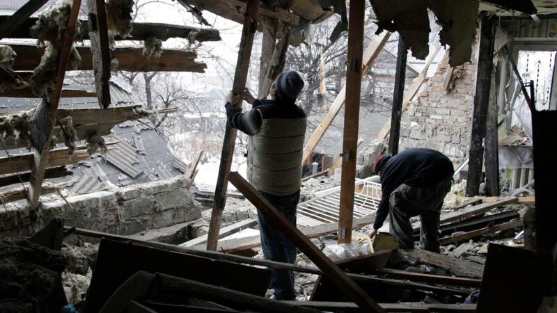 Local residents remove debris at a house damaged by recent shelling in Donetsk, eastern Ukraine, on Wednesday. Photograph: Alexander Ermochenko/Reuters