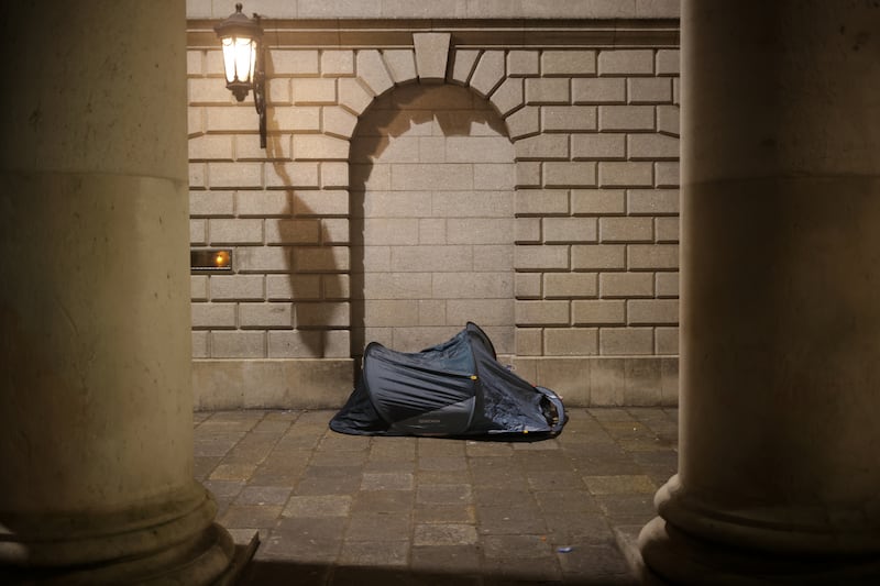 A homeless person sleeps in the early morning on Dublin’s College Green at the Bank of Ireland building, in temperatures hovering around -3 degrees. Photograph: Chris Maddaloni
