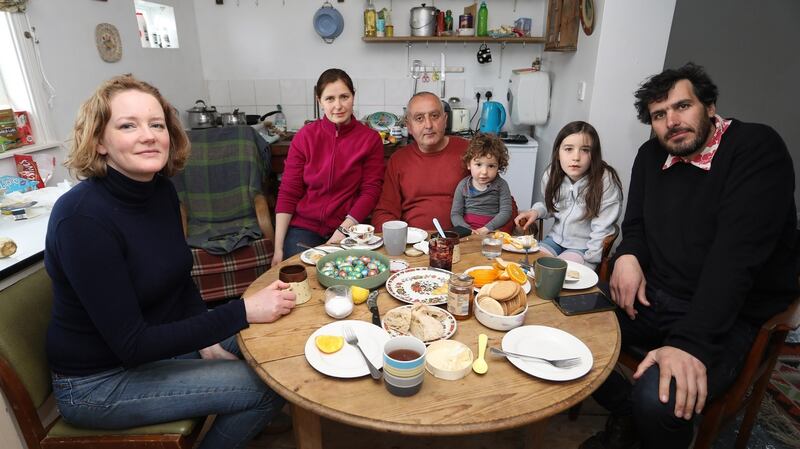 Rebecca, Viktoriia, Mamuka, Krystyna, Nancy and Will share a meal together in the home the Ukranian family are living in. Photograph: Lorraine Teevan