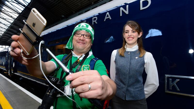 A Japanese tourist gets a photo with steward Katie Scanlan, from Kildare, at the Belmond Grand Hibernian at Heuston Station in Dublin on Tuesday. Photograph: Cyril Byrne/The Irish Times