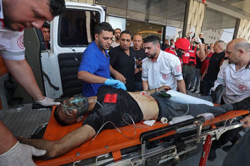 Palestinian medics transport an injured person into a hospital during  Israeli military's operation in Jenin city in the occupied West Bank. Photograph: Jaafar Ashtiyeh/AFP via Getty Images