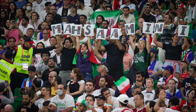 Iranian supporters hold letters forming the name Mahsa Amini as a government protest at a World Cup match between Iran and the US on November 29th. Photograph: Virginia Lefour/Belga Mag/AFP via Getty