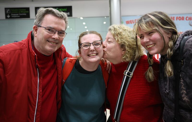 Leah Casey (centre) is welcomed home by her dad and mom Paul Casey and Valerie McGrath and her sister Robin Casey  at Dublin Airport. Photo: Bryan O’Brien / The Irish Times

