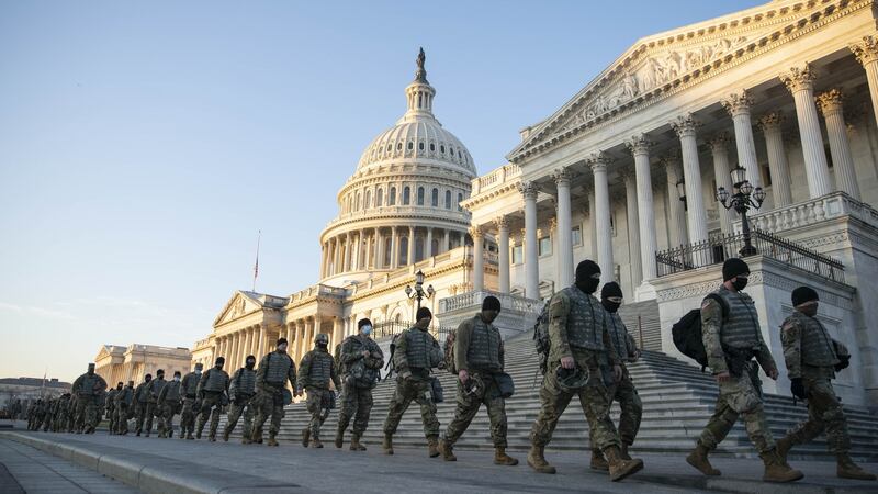 Members of the National Guard walk outside of the US Capitol building in Washington, DC on Wednesday. Photograph: Sarah Silbiger/Bloomberg