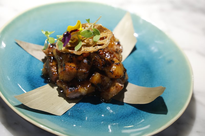 Sticky pork 'Gula Melaka', caramalised ginger, crispy leek and goji berry.  Photograph Nick Bradshaw