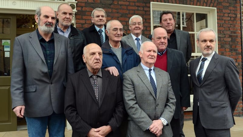 Hooded men: Michael Donnelly, Patrick McNally, Brian Turley, Gerry McKerr, Francie McGuigan, Joe Clarke, Jim Auld, Kevin Hannaway and Liam Shannon with Colm O’Gorman of Amnesty International Ireland, which has acted on their behalf. Photograph: Cyril Byrne