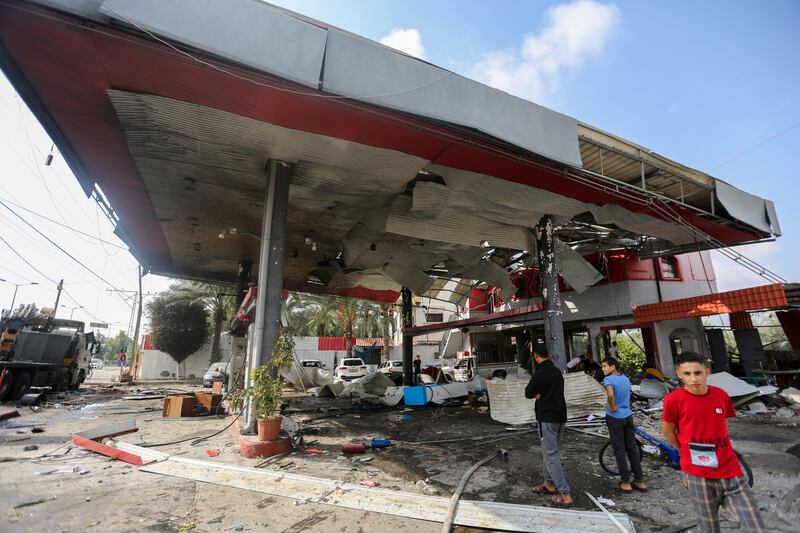 Citizens inspect the remains of a petrol station destroyed during Israeli raids in Khan Yunis, Gaza, on Tuesday. Photograph: Ahmad Hasaballah/Getty Images