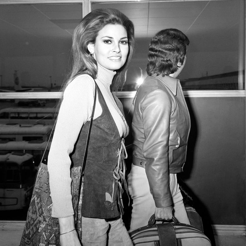 Raquel Welch arrives at Heathrow airport with husband Patrick Curtis in 1971. Photograph: PA