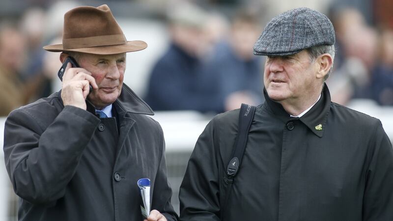 Racing manager Frank Berry with JP McManus:  One trainer estimates McManus has over 500 horses in training in Ireland and another 500 either out of training, getting pre-trained or simply retired. Photograph:  Alan Crowhurst/Getty Images