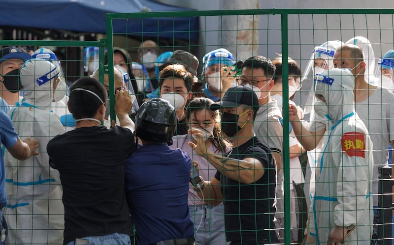 People try to break out of quarantine fence during a protest in Shanghai on Monday. Photograph: Alex Plavevski/EPA-EFE