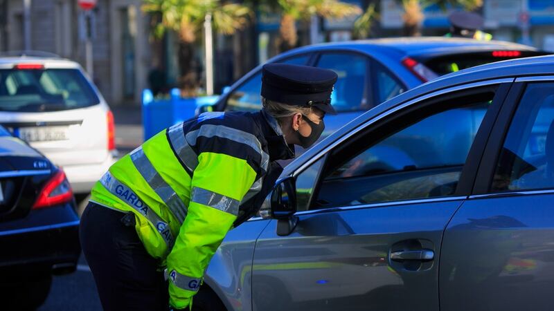 A garda speaks to a car’s occupants  at a checkpoint on O’Connell Bridge in Dublin as Level 5 restrictions against  Covid-19 continue to be enforced, on Monday, November 2nd. Photograph: Collins