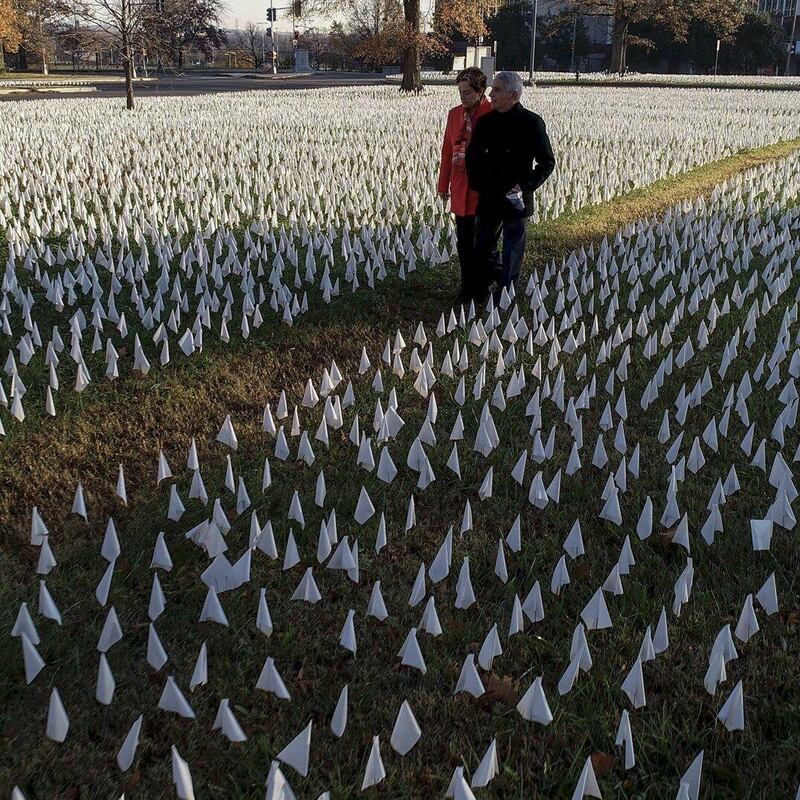 Dr Anthony Fauci and his wife, Christine Grady, walk through the Covid-19 installation In America, How Could This Happen in Washington DC.  Photograph: Visko Hatfield/National Geographic for Disney+