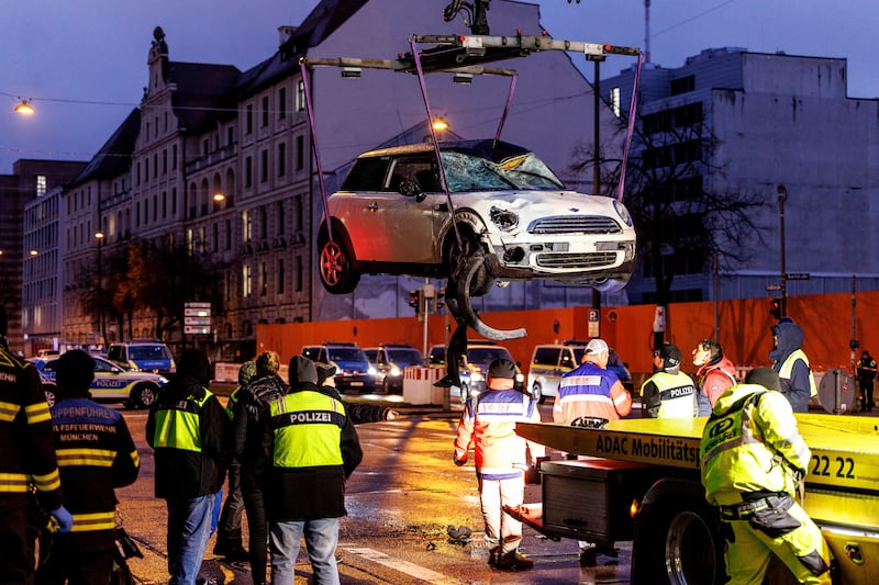 A car is lifted on to a lorry at the scene of the attack. Photograph: Matthias Balk/dpa/AP