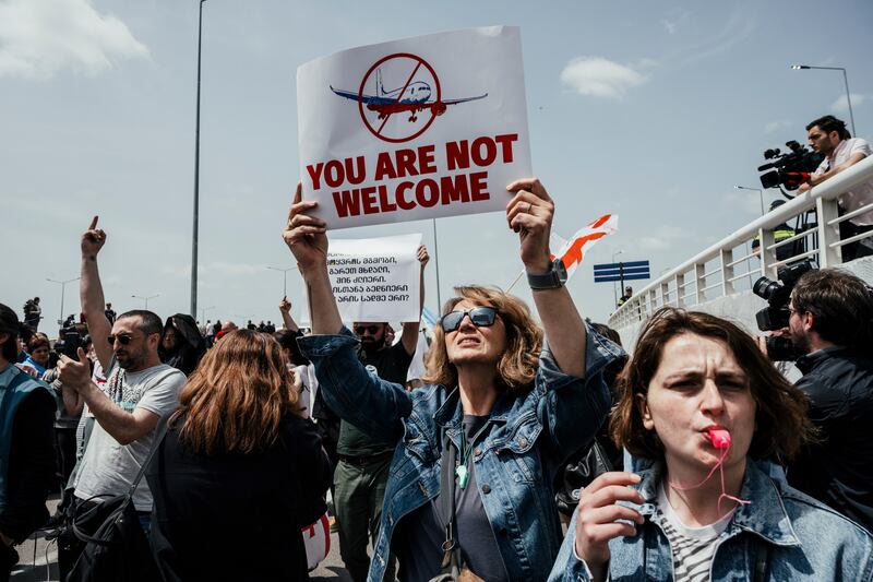 Protesters gather outside Tbilisi International Airport in anticipation of the first direct flight from Russia to Georgia in more than three years in May. Photograph: Tako Robakidze/The New York Times
                      