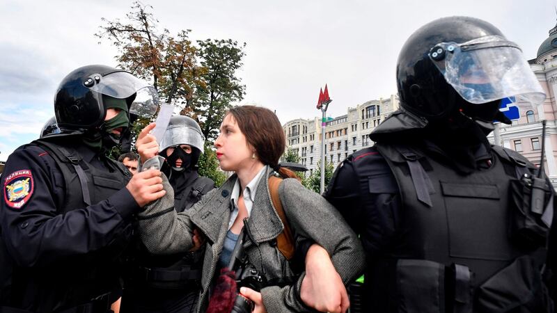 Riot police officers detain a journalist during a rally urging fair elections at Moscow’s Pushkinskaya Square. Photograph: Alexander Nemenov/AFP/Getty Images