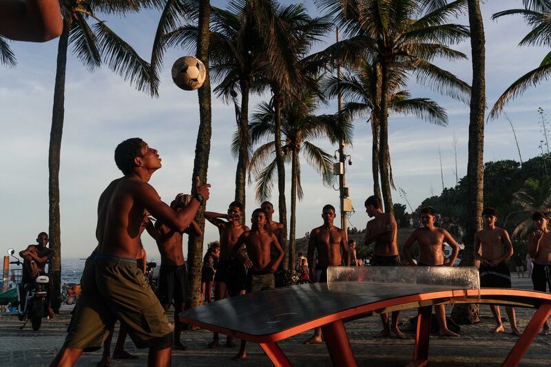 Men play ball games on Arpoador Beach, Rio de Janeiro. Photograph: Ian Cheibub/The New York Times