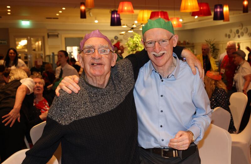 George Mooney (left) and volunteer Kevin Fitzsimons at the Friends of the Elderly Christmas dinner. Photograph: Laura Hutton