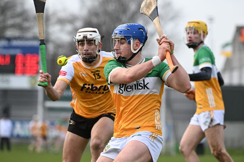 James Mahon of Offaly looks to get his shot away as Seaan Elliott of Antrim closes in. Photograph: Andrew Paton/Inpho