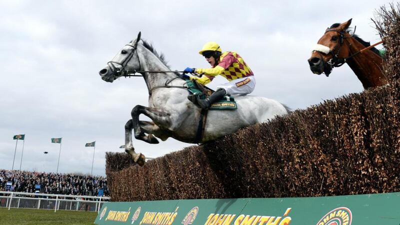 Dynaste and Tom Scudamore (left) jump the final fence on their way to victory in the John Smiths Mildmay Novices Chase  at Aintree. Photograph: John Giles/PA Wire