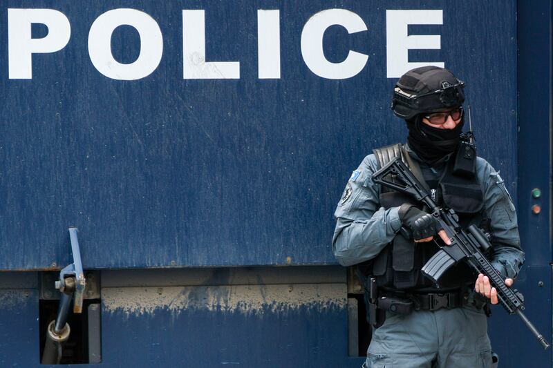 A Kosovo police officer guards a municipal building. Photograph: Marjan Vucetic/AP