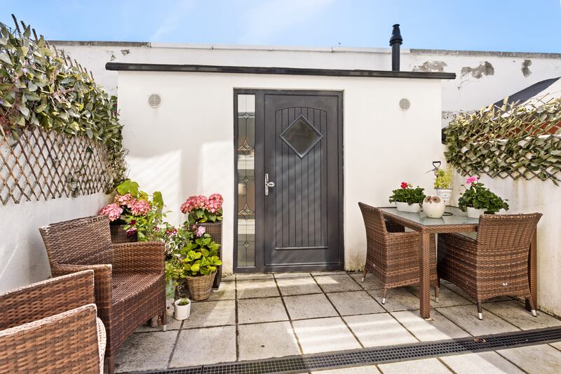 A rear patio houses a small shed that is plumbed for a washing machine and dryer. Photograph: Angela Mujica