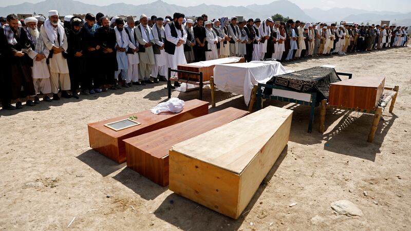 Men offer funeral prayers over the coffins of victims of a bomb blast at a wedding in Kabul, Afghanistan. Photograph: Mohammad Ismail/Reuters