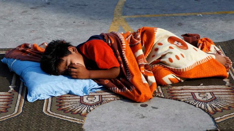 A boy sleeps in a United Nations-run school sheltering displaced Palestinians in Gaza City. Palestinian militants in the Gaza Strip resumed rocket fire into Israel today after Egyptian-mediated talks in Cairo failed to extend a 72-hour truce in a month-long war. Photograph: Reuters