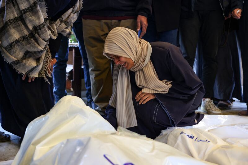 A relative mourns over the bodies of four members of the al-Qadra family, two children and their parents, killed in an Israeli strike the day before the Israel-Hamas ceasefire took effect. Photograph: Bashar Taleb/AFP via Getty Images