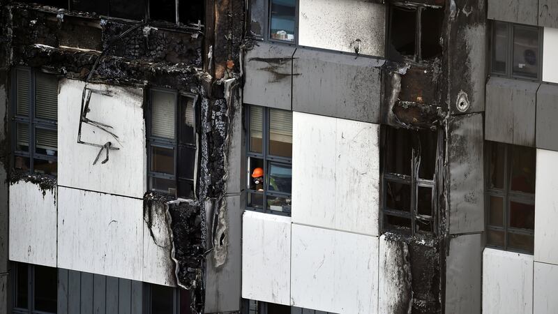 The remains of the cladding on the Grenfell Tower in Kensington, London. Photograph: Hannah McKay/Reuters